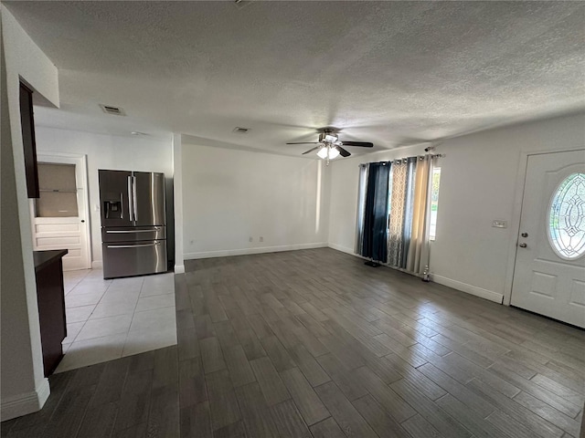 12009 Washington St, Seffner, FL 33584 - foyer featuring a textured ceiling, dark wood-style flooring, and a ceiling fan