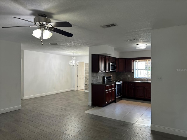 12009 Washington St, Seffner, FL 33584 - kitchen featuring stainless steel appliances, a chandelier, a textured ceiling, ceiling fan, and tasteful backsplash