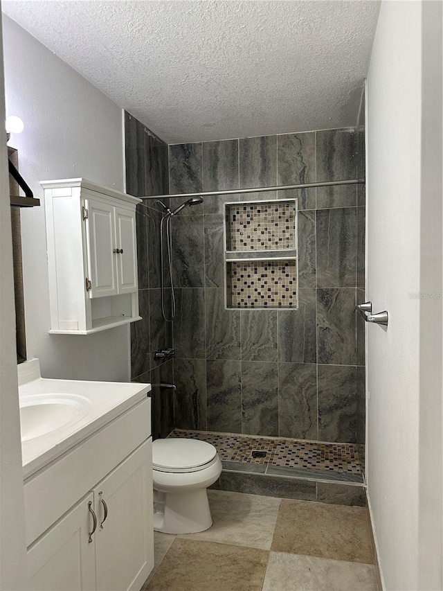 12009 Washington St, Seffner, FL 33584 - bathroom featuring a textured ceiling, vanity, and a tile shower