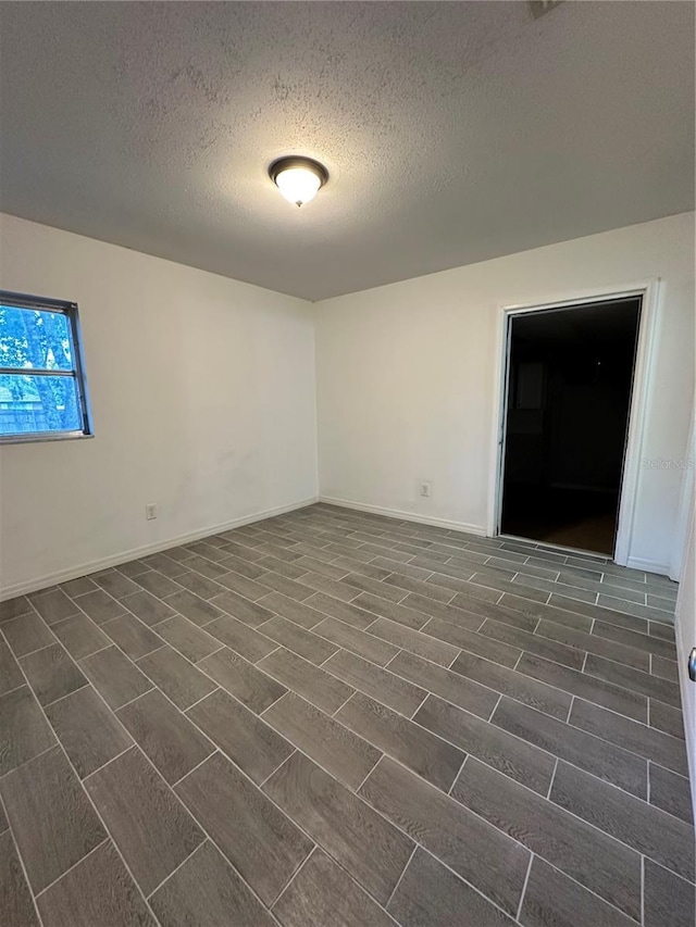 12009 Washington St, Seffner, FL 33584 - unfurnished room featuring a textured ceiling and baseboards