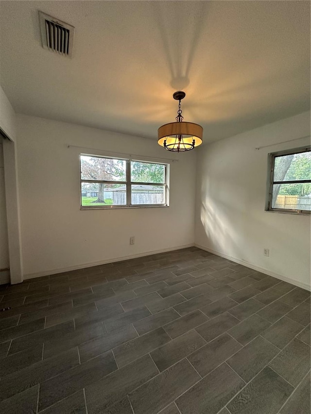 12009 Washington St, Seffner, FL 33584 - spare room featuring a chandelier and baseboards