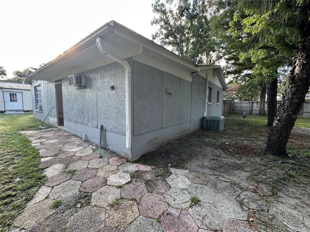 12009 Washington St, Seffner, FL 33584 - view of side of property featuring an AC wall unit and a central air condition unit