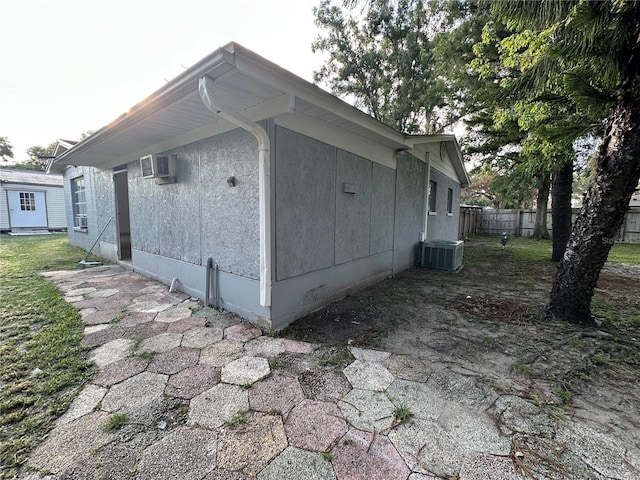 12009 Washington St, Seffner, FL 33584 - view of side of property featuring an AC wall unit and a central air condition unit