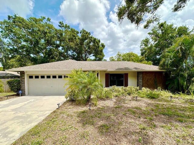 1548 Foxboro Dr, Palm Harbor, FL 34683 - ranch-style home with an attached garage and driveway