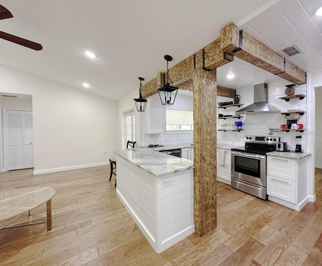 1548 Foxboro Dr, Palm Harbor, FL 34683 - kitchen with stainless steel electric range oven, wall chimney exhaust hood, white cabinetry, lofted ceiling, and decorative backsplash