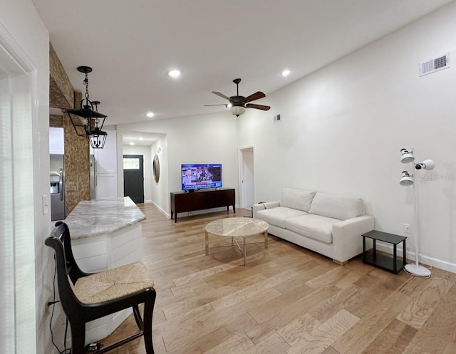 1548 Foxboro Dr, Palm Harbor, FL 34683 - living room featuring light wood finished floors, ceiling fan, and recessed lighting