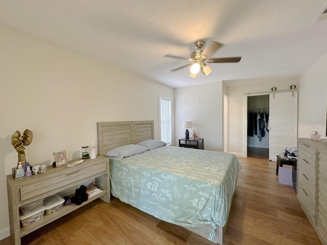 1548 Foxboro Dr, Palm Harbor, FL 34683 - bedroom with wood finished floors and ceiling fan