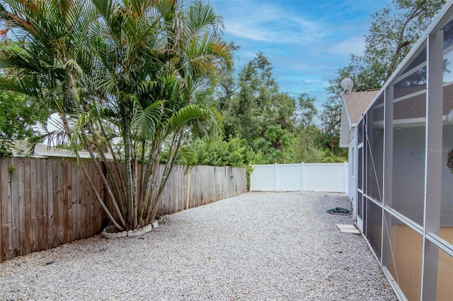 4317 S Hale Ave, Tampa, FL 33611 - fenced backyard with glass enclosure and a patio area