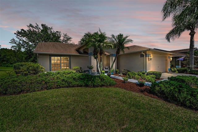 1115 Ashbourne Cir, Trinity, FL 34655 - ranch-style house with stucco siding, an attached garage, a front yard, and concrete driveway