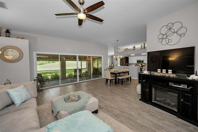 1115 Ashbourne Cir, Trinity, FL 34655 - living room with ceiling fan, a chandelier, and light wood finished floors