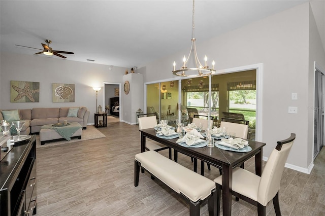 1115 Ashbourne Cir, Trinity, FL 34655 - dining area with a chandelier, ceiling fan, and light wood-type flooring