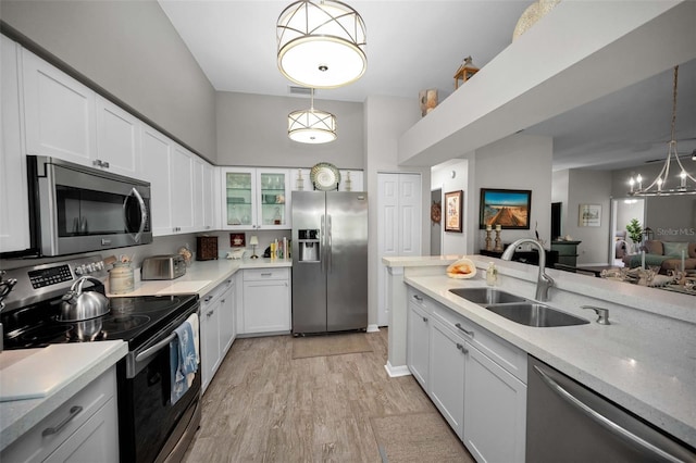 1115 Ashbourne Cir, Trinity, FL 34655 - kitchen featuring stainless steel appliances, light wood-style floors, white cabinets, and light countertops