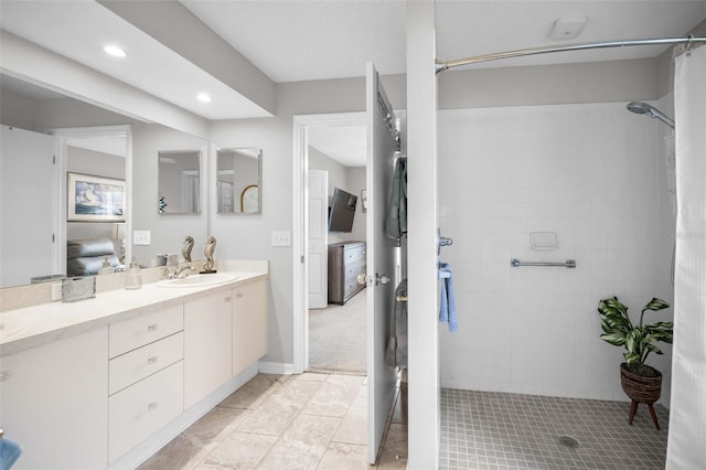 1115 Ashbourne Cir, Trinity, FL 34655 - ensuite bathroom featuring double vanity, tiled shower, and recessed lighting
