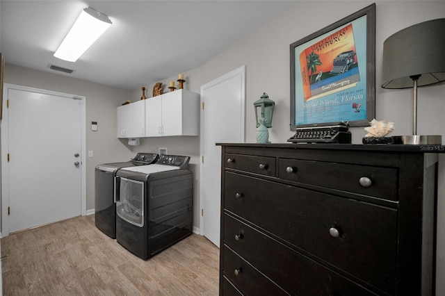1115 Ashbourne Cir, Trinity, FL 34655 - washroom featuring separate washer and dryer, cabinet space, and light wood-style floors