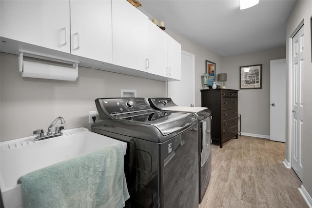 1115 Ashbourne Cir, Trinity, FL 34655 - laundry area with cabinet space, washer and dryer, and light wood-type flooring