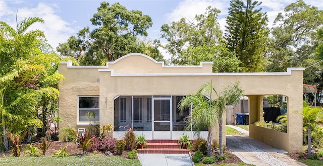 3611 W Bay To Bay Blvd, Tampa, FL 33611 - rear view of property with stucco siding and a sunroom