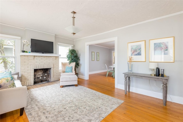 3611 W Bay To Bay Blvd, Tampa, FL 33611 - living room with light wood-style floors, a brick fireplace, ornamental molding, and a textured ceiling