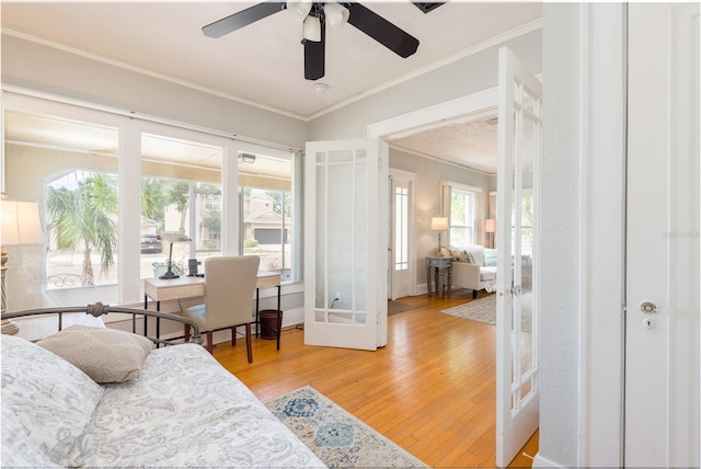 3611 W Bay To Bay Blvd, Tampa, FL 33611 - living area featuring ornamental molding, light wood-type flooring, french doors, and a ceiling fan