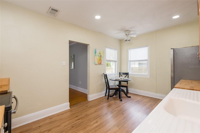 3611 W Bay To Bay Blvd, Tampa, FL 33611 - kitchen with freestanding refrigerator, a ceiling fan, light wood-type flooring, recessed lighting, and wood counters