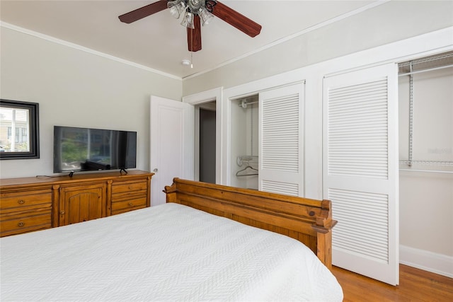 3611 W Bay To Bay Blvd, Tampa, FL 33611 - bedroom featuring wood finished floors, two closets, ornamental molding, and a ceiling fan