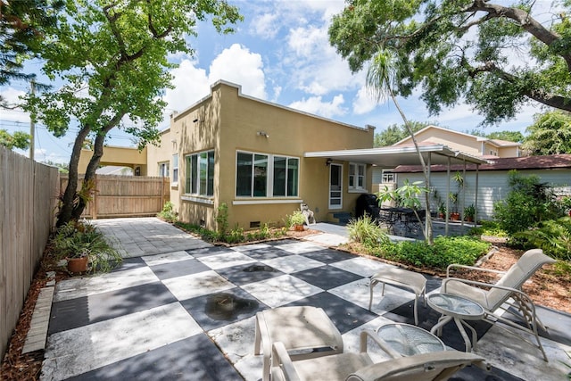 3611 W Bay To Bay Blvd, Tampa, FL 33611 - back of property featuring stucco siding and a patio area