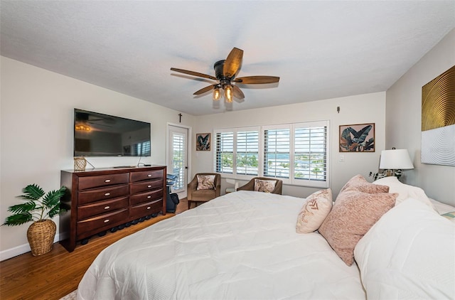 1324 Pasadena Ave S Unit 501, South Pasadena, FL 33707 - bedroom with wood finished floors, access to exterior, and a ceiling fan