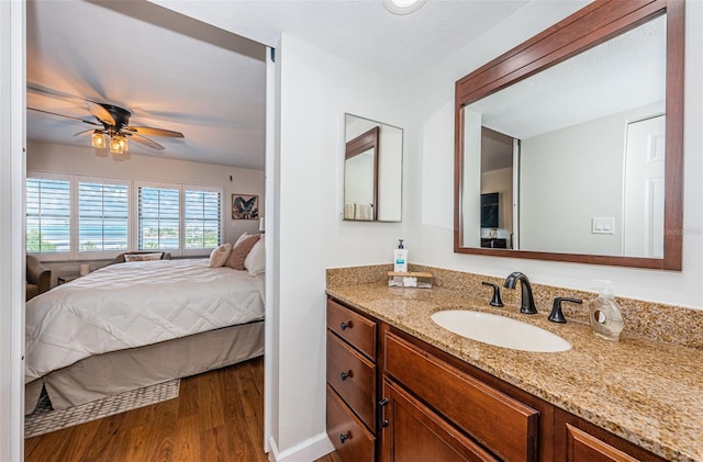 1324 Pasadena Ave S Unit 501, South Pasadena, FL 33707 - bathroom with ensuite bathroom, vanity, wood finished floors, and ceiling fan