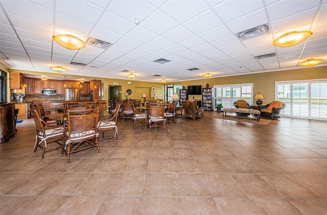 1324 Pasadena Ave S Unit 501, South Pasadena, FL 33707 - dining area with light tile patterned floors and a paneled ceiling