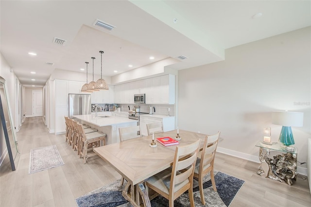 400 150th Ave Unit 504, Madeira Beach, FL 33708 - dining room with light wood finished floors and recessed lighting