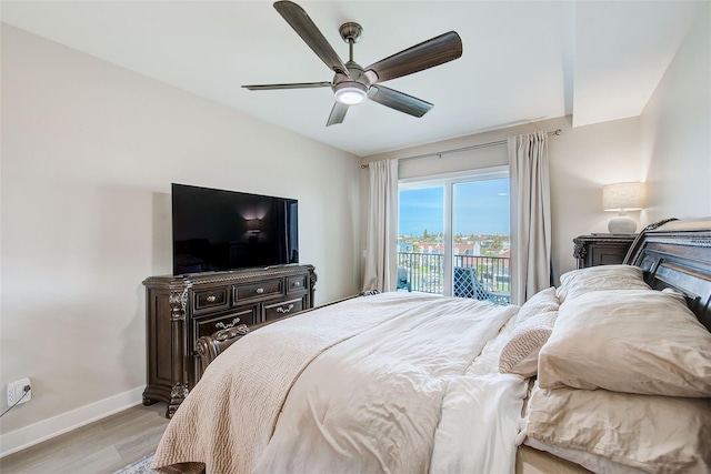 400 150th Ave Unit 504, Madeira Beach, FL 33708 - bedroom with access to exterior, light wood-type flooring, and ceiling fan