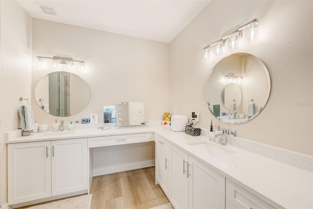 400 150th Ave Unit 504, Madeira Beach, FL 33708 - full bathroom featuring double vanity and wood finished floors