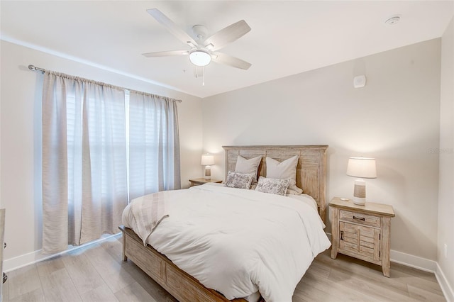 400 150th Ave Unit 504, Madeira Beach, FL 33708 - bedroom with light wood-style floors and ceiling fan