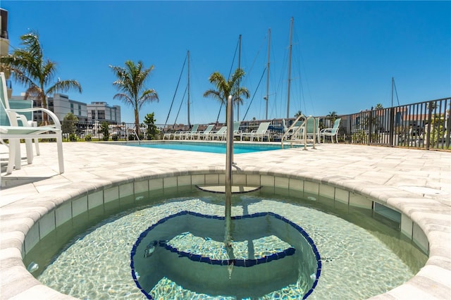 400 150th Ave Unit 504, Madeira Beach, FL 33708 - community pool featuring a hot tub and a patio