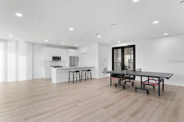 400 150th Ave Unit 504, Madeira Beach, FL 33708 - dining area with french doors, light wood-style floors, and recessed lighting