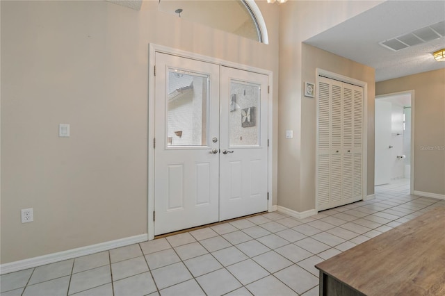 8671 Cypress Lakes Blvd, New Port Richey, FL 34653 - entrance foyer featuring light tile patterned flooring and french doors