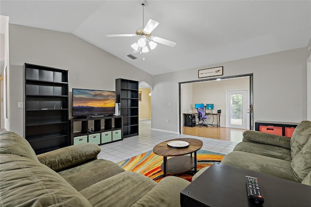 8671 Cypress Lakes Blvd, New Port Richey, FL 34653 - living room with vaulted ceiling, ceiling fan, arched walkways, and tile patterned flooring