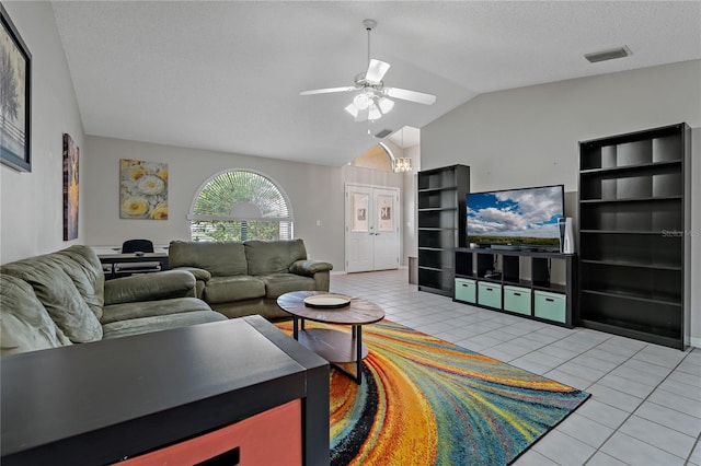 8671 Cypress Lakes Blvd, New Port Richey, FL 34653 - living room with vaulted ceiling, light tile patterned flooring, ceiling fan, french doors, and a textured ceiling