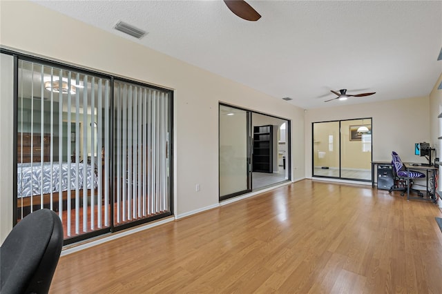 8671 Cypress Lakes Blvd, New Port Richey, FL 34653 - empty room with a ceiling fan, an office area, and wood finished floors