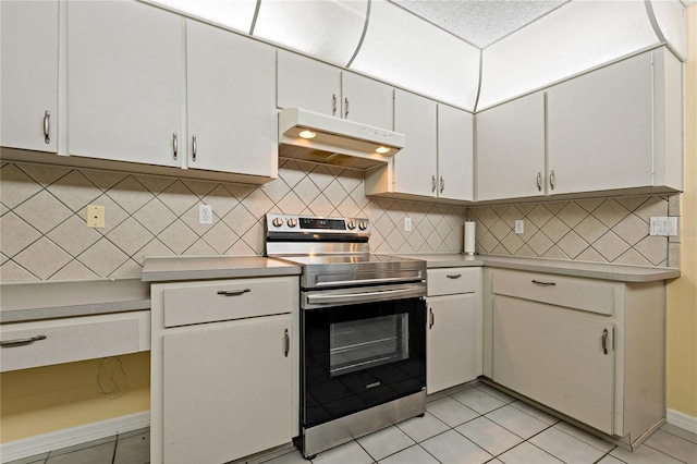 8671 Cypress Lakes Blvd, New Port Richey, FL 34653 - kitchen with electric stove, under cabinet range hood, backsplash, and light countertops