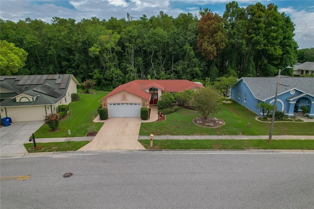 8671 Cypress Lakes Blvd, New Port Richey, FL 34653 - view of front of house with concrete driveway, a front yard, and a garage