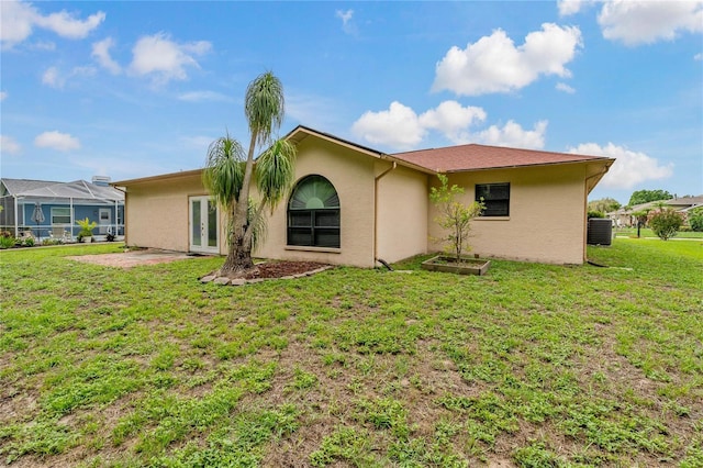 8671 Cypress Lakes Blvd, New Port Richey, FL 34653 - back of property featuring stucco siding, a yard, french doors, and a patio