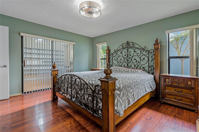 8671 Cypress Lakes Blvd, New Port Richey, FL 34653 - bedroom with wood finished floors and a textured ceiling