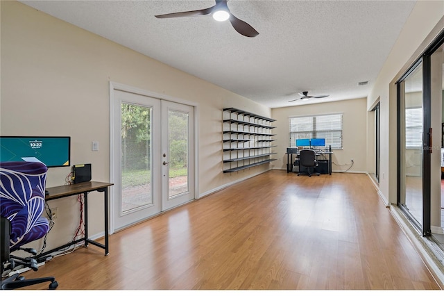 8671 Cypress Lakes Blvd, New Port Richey, FL 34653 - office area featuring a ceiling fan, a textured ceiling, french doors, and wood finished floors