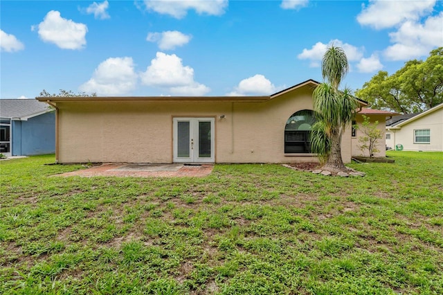 8671 Cypress Lakes Blvd, New Port Richey, FL 34653 - back of property with french doors, stucco siding, a yard, and a patio area