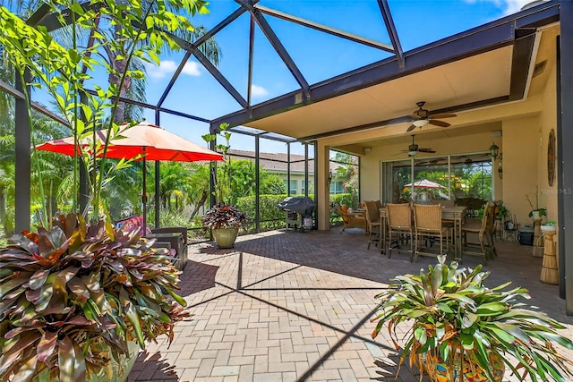 15744 Crystal Waters Dr, Wimauma, FL 33598 - view of patio / terrace with glass enclosure, ceiling fan, outdoor dining space, and grilling area