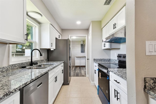 2902 Wheeler St, Bartow, FL 33830 - kitchen with appliances with stainless steel finishes, under cabinet range hood, light stone counters, and white cabinetry