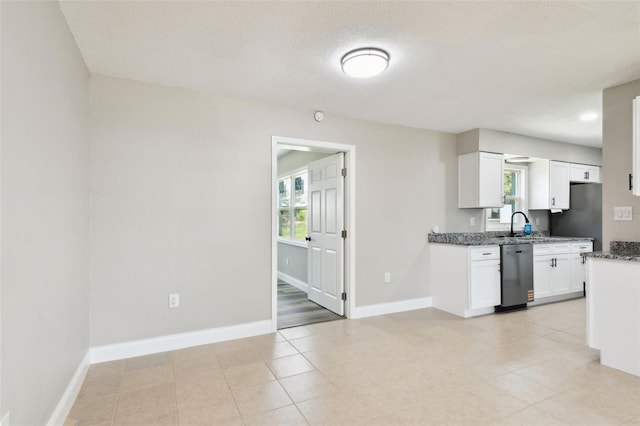 2902 Wheeler St, Bartow, FL 33830 - kitchen featuring dishwasher, dark stone counters, white cabinetry, fridge, and light tile patterned floors