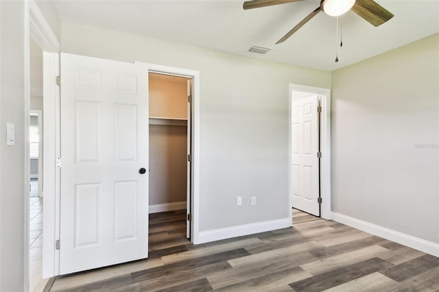 2902 Wheeler St, Bartow, FL 33830 - unfurnished bedroom featuring a walk in closet, wood finished floors, a closet, and ceiling fan