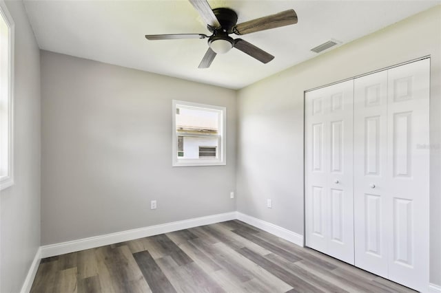 2902 Wheeler St, Bartow, FL 33830 - unfurnished bedroom featuring wood finished floors, a closet, and a ceiling fan