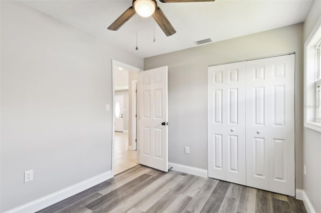 2902 Wheeler St, Bartow, FL 33830 - unfurnished bedroom featuring wood finished floors, a closet, and ceiling fan